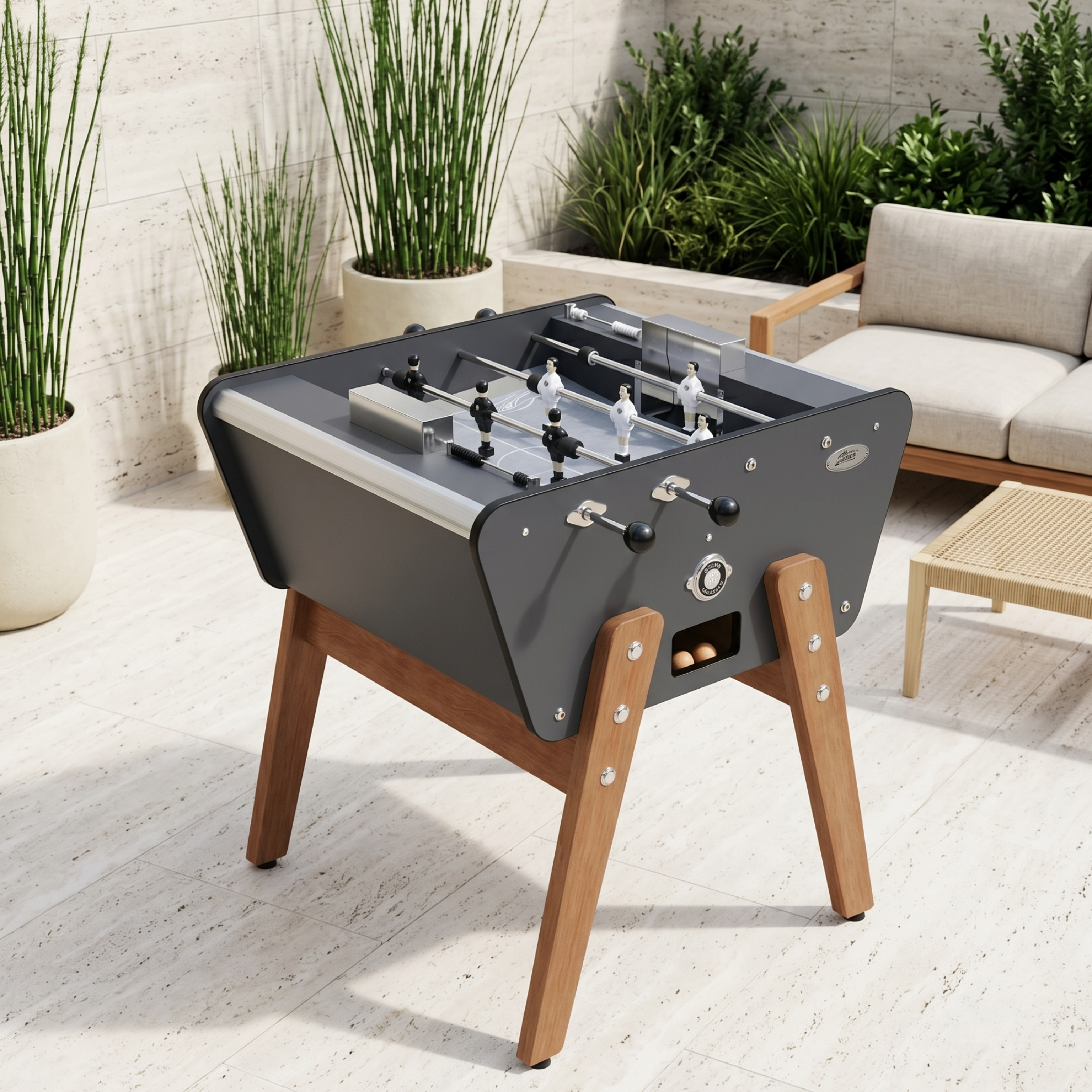 Baby-foot 2 joueurs Stella Toi&Moi Outdoor gris anthracite installé sur une terrasse, design contemporain et robuste pour une expérience de jeu en duo en extérieur.